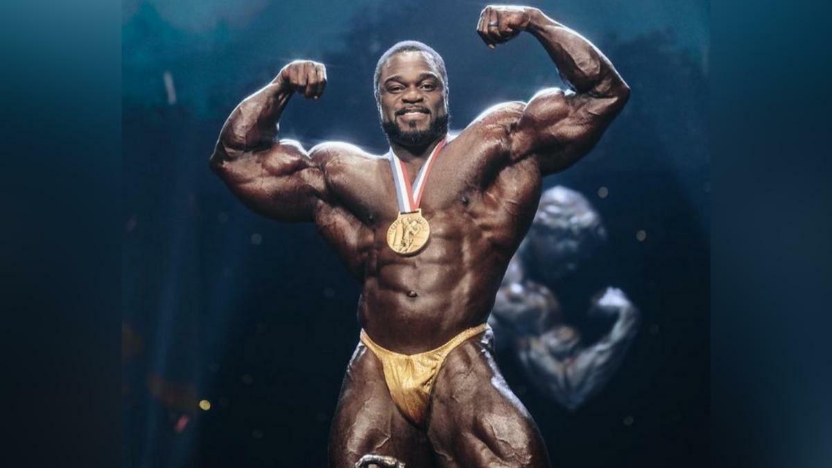 2022 Arnold Classic winner Brandon Curry posing on stage